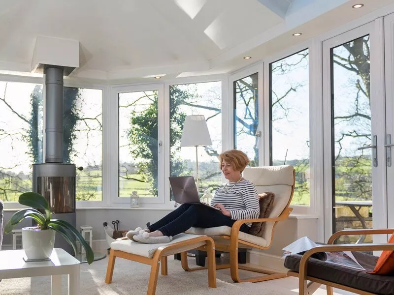 Lady relaxing in conservatory