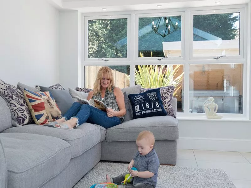 Mother and son relaxing inside a conservatory